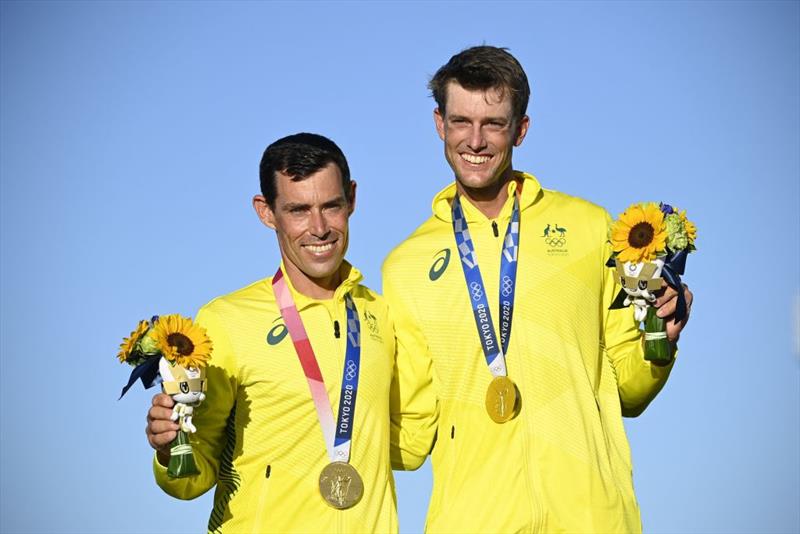 (L-R) Gold medallists Australia's Mathew Belcher and Will Ryan celebrate on the podium after the men's two-person dinghy 470 medal race during the Tokyo 2020 Olympic Games sailing competition at the Enoshima Yacht Harbour - photo © Olivier Morin / AFP