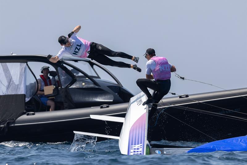 McKiwis take a dive soon after the finish of the Medal Race - Mens Skiff - Paris2024 Olympic Sailing Event - Marseille - August 2, 2024 photo copyright World Sailing / Sander van der Borch taken at Royal Akarana Yacht Club and featuring the 49er class