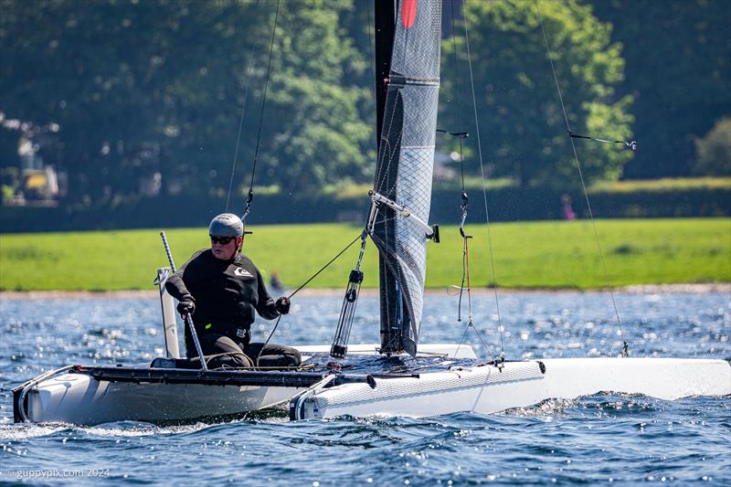 Hugh MacGregor checks his competition during the Rutland Cat Open 2024 photo copyright Gordon Upton / www.guppypix.com taken at Rutland Sailing Club and featuring the A Class Catamaran class