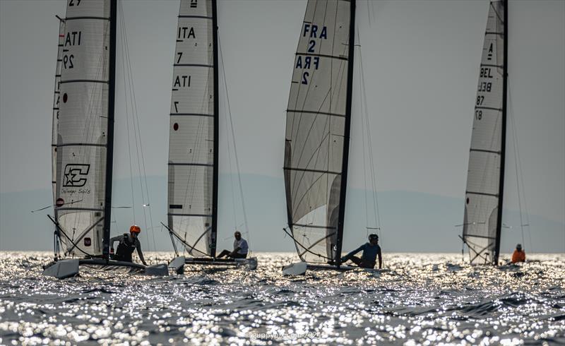 A Class Cat Regata Nazionale - How to identify the categories in a mixed fleet. Open (foiling) category: no red dot, Classic : big red dot. It works very well as we see here photo copyright Gordon Upton / www.guppypix.com taken at Centro Velico Punta Ala and featuring the A Class Catamaran class