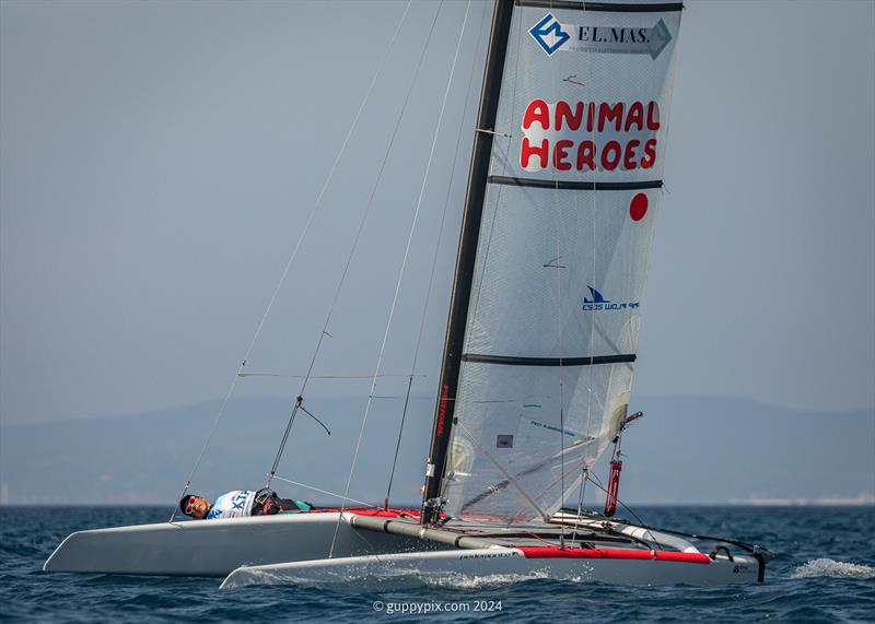 A Class Cat Regata Nazionale - Italian sailor Marco Puppio gets low on his Classic old DNA photo copyright Gordon Upton / www.guppypix.com taken at Centro Velico Punta Ala and featuring the A Class Catamaran class