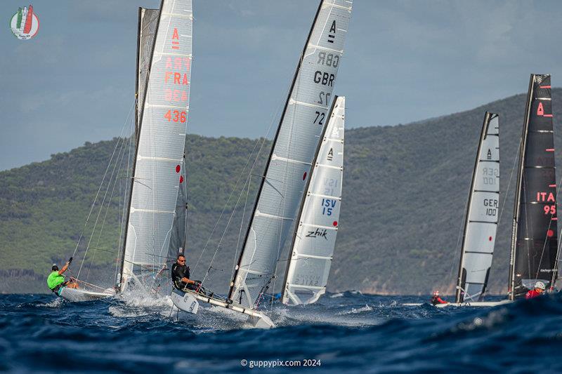 GBR sailor Owen Cox having the time of his life, in the bath-like sea temperatures - A Class Cat Worlds at Punta Ala day 1 photo copyright Gordon Upton / www.guppypix.com taken at Centro Velico Punta Ala and featuring the A Class Catamaran class