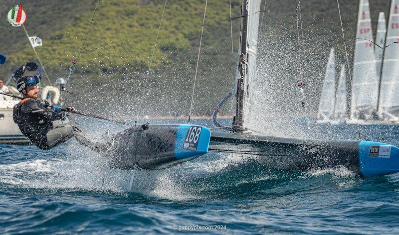 Robin Maeder is the Swiss Champ (he is heroically burning the midnight oil as the fleet repair man) - A Class Cat Worlds at Punta Ala day 2 photo copyright Gordon Upton / www.guppypix.com taken at Centro Velico Punta Ala and featuring the A Class Catamaran class