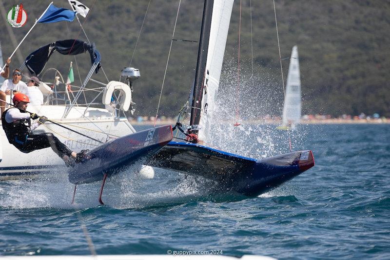 Giorgio Lais, hotdogging the finish - A Class Cat Worlds at Punta Ala day 2 photo copyright Gordon Upton / www.guppypix.com taken at Centro Velico Punta Ala and featuring the A Class Catamaran class