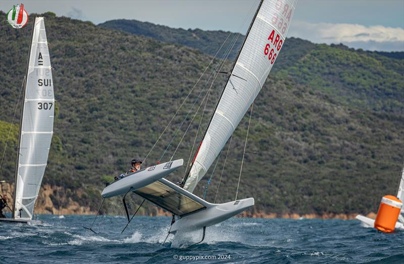 A Class Cat Worlds at Punta Ala - Ian Rodger, ARG 666, appears totally unconcerned that his boat is rather loose at the top mark in 22 kts photo copyright Gordon Upton / www.guppypix.com taken at Centro Velico Punta Ala and featuring the A Class Catamaran class