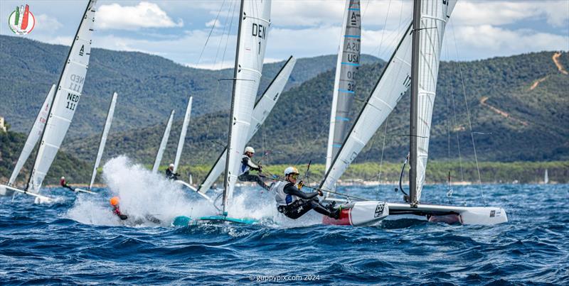 A Class Cat Worlds at Punta Ala - The top mark on the Open course, first lap is always good for potential crowd-pleasing moments. Here Thomas Paasch, DEN 1 gets a teabagging photo copyright Gordon Upton / www.guppypix.com taken at Centro Velico Punta Ala and featuring the A Class Catamaran class