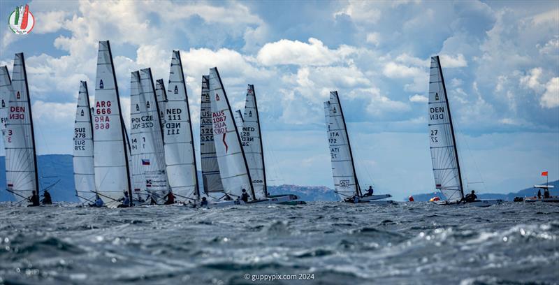 A Class Cat Worlds at Punta Ala: The start of the final Open race of the 2024 Worlds at PuntAla in challenging top end breeze.  The champion, Kuba Surowiec, is already out of shot photo copyright Gordon Upton / www.guppypix.com taken at Centro Velico Punta Ala and featuring the A Class Catamaran class