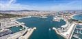 The 2024 America's Cup Regattas will be run out of the old port in Barcelona. America's Cup Event is located in the World Trade Centre building in the centre of this image. Spectators will be able to view the racing off the beach in the right background © ACE