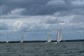 David Smith's East Coast One Design Wizard leads the fleet during Burnham Week 2025 © Petru Balau Sports Photography / sports.hub47.com