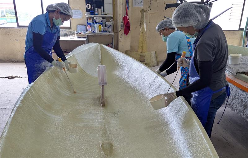 The Element 6 Evolution team at work laying the fibreglass on an ILCA hull - photo © Mark Jardine