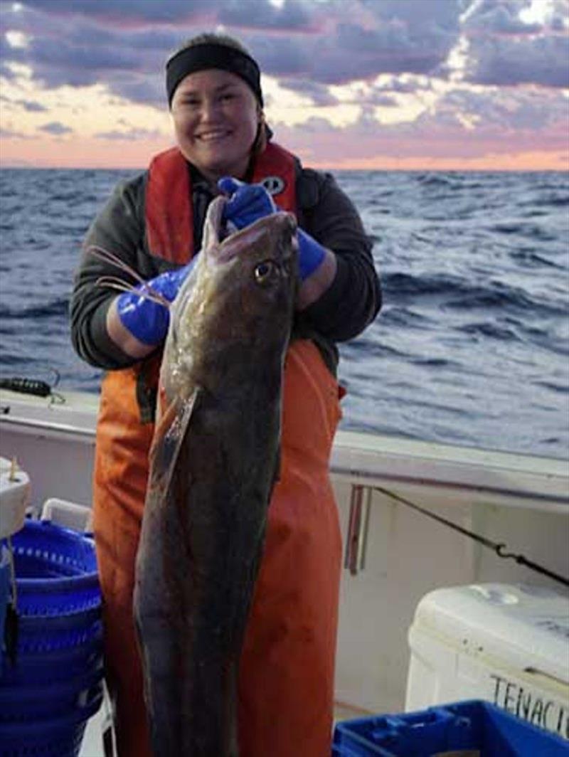 Cooperative Research Branch field biologist, Emma Fowler, holds one of the more impressively sized white hake during the Fall 2021 survey. - photo © NOAA Fisheries / Giovanni Gianesin