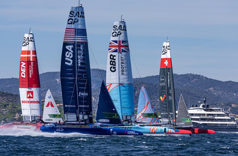 Denmark SailGP Team, USA SailGP Team, Great Britain SailGP Team, and Switzerland SailGP Team sail past the superyacht Here Comes The Sun on Race Day 1 of the Range Rover France Sail Grand Prix in Saint Tropez, - photo © David Gray / SailGP