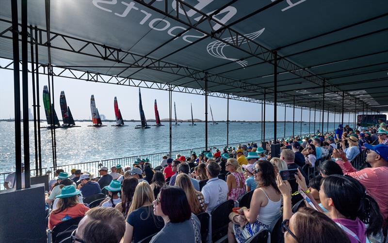 Spectators in the grandstand watch as the SailGP fleet of F50 catamarans pass on Race Day 1 of the Mubadala Abu Dhabi Sail Grand Prix presented by Abu Dhabi Sports Council in Abu Dhabi, United Arab Emirates. 13th January - photo © Christopher Pike for SailGP