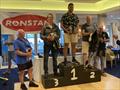 Podium in the Ronstan British Finn Nationals at Christchurch (l-r) Nick Craig 3rd, Cameron Tweedle 1st, John Greenwood 2nd © Lotte Johnson & Gareth James