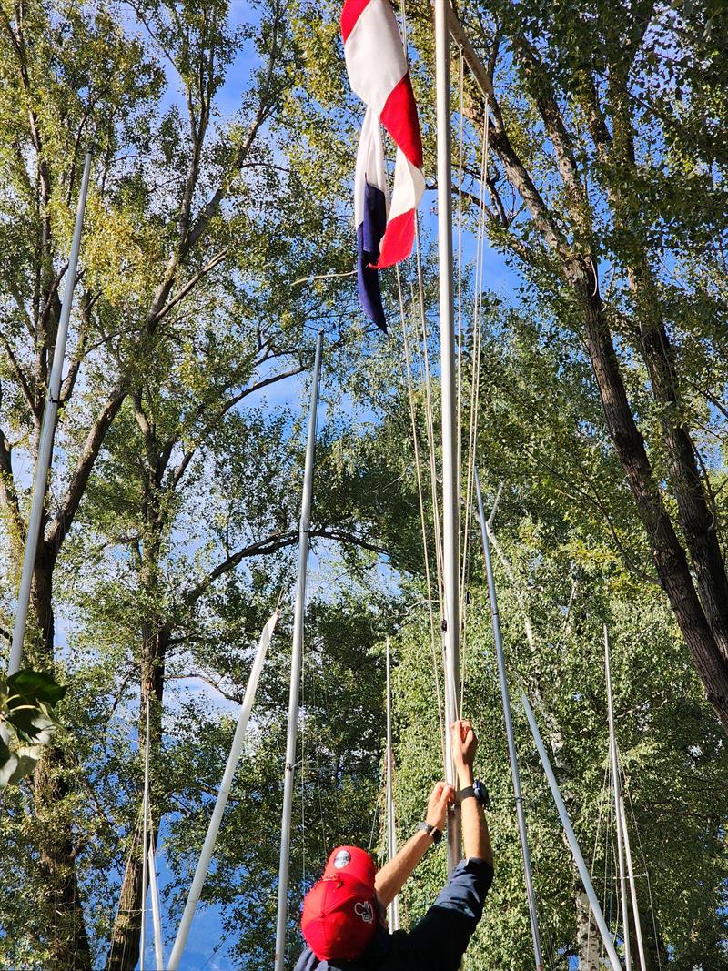 Raising the flag to signal the end of the day's racing on day 4 of the Fireball Europeans at Maccagno photo copyright Frank Miller taken at Unione Velica Maccagno and featuring the Fireball class