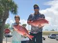 Two fishermen holding red snapper. Photo submission for NOAA Fisheries Southeast Fishing Photo Contest