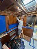 Hull #9 - Thomas installing overhead molding