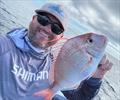 Stuart with a frying pan snapper. A fish commonly caught in the bay in winter away from heavy reef