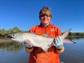 Erica with an example of the blue salmon that are so prolific in our streams and on our flats these days