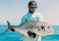 Shaun, the skipper of Saltwater Playground Charters with a recent GT capture from the offshore shoal country