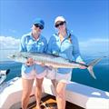 Happy girls cradling a nice spaniard caught aboard a Saltwater Playground Charter