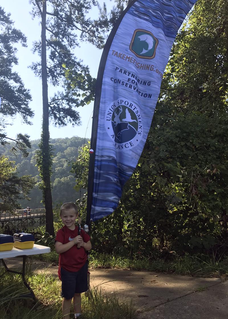 Young boy is excited to receive new fishing gear, compliments of USA's partner Pure Fishing photo copyright Union Sportsmen’s Alliance taken at  and featuring the Fishing boat class