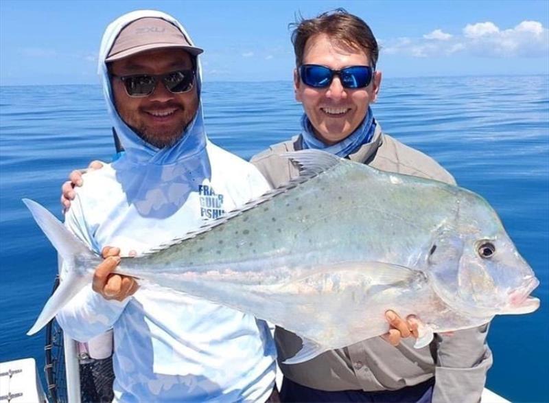 Tri from Fraser Guided Fishing with one of his clients and a nice diamond trevally photo copyright Fisho's Tackle World taken at  and featuring the Fishing boat class