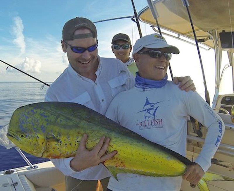 Randy and Alex Rigby pose with Todd Bell, who caught this mahi on 15-pound spinning tackle on Randy and Jill's Fisherman 257. - photo © Grady-White