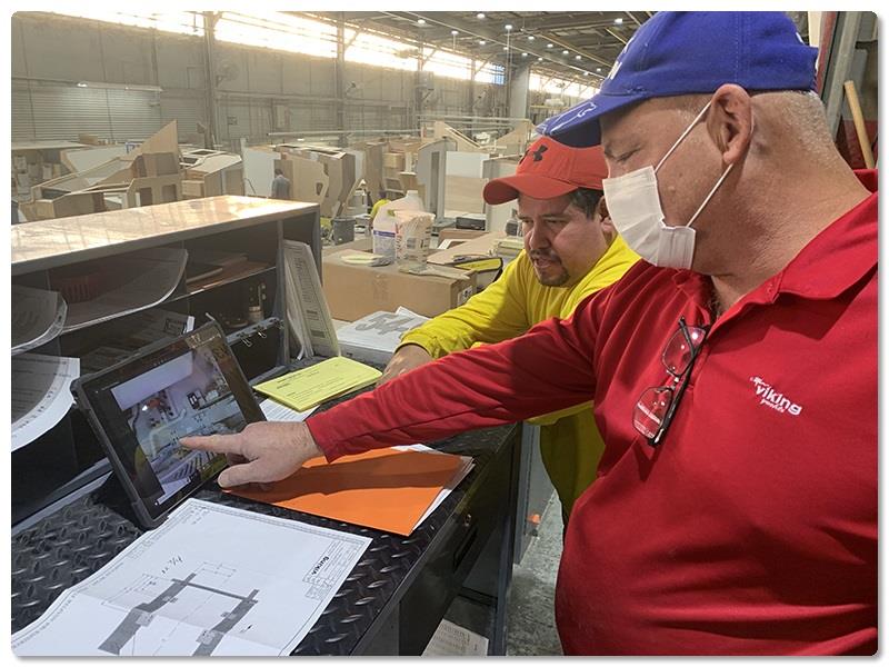 Mechanical Department Foreman Bill Langel, a 24-year Viking veteran, and Line 4 Mechanical Leadman Jhovanny Ramos review the installation of a Seakeeper in a 54 Convertible - photo © Viking Yachts