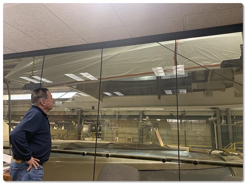Vice President of Manufacturing Al Uhl watches (through his office's glass wall) - photo © Viking Yachts
