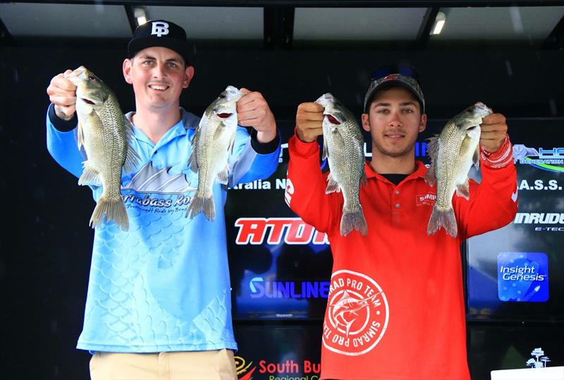 Stretch getting his baby bass a metre closer to camera than Dane's - photo © Fisho's Tackle World