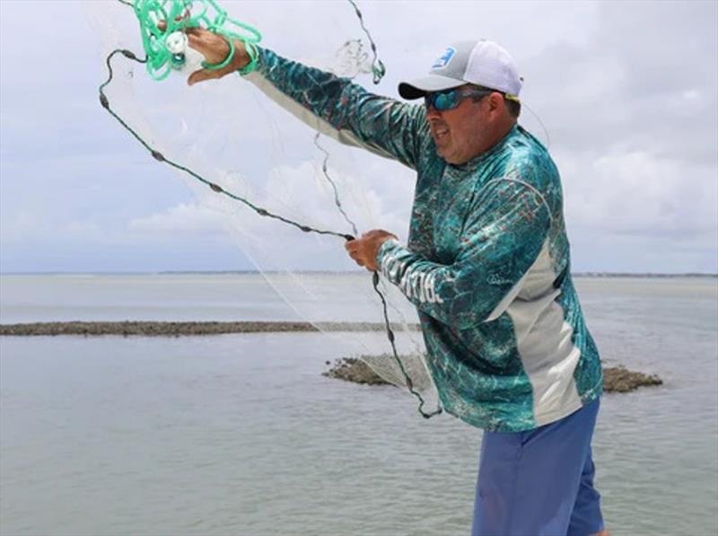 When thrown correctly, a cast net will open into a pancake shape photo copyright Calcutta Outdoors taken at  and featuring the Fishing boat class