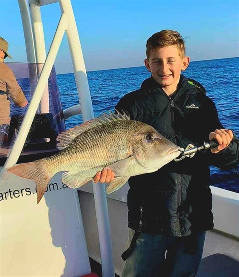 Fish the fringes of the reef if you like grassies. This young lad had a great day out with Hot Reels - photo © Fisho's Tackle World