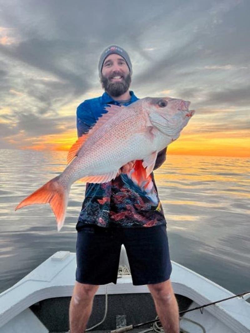 Ray Green's great snapper shot tells the story. Oily calm and cloudy with the sun on the horizon - snapper time - photo © Fisho's Tackle World