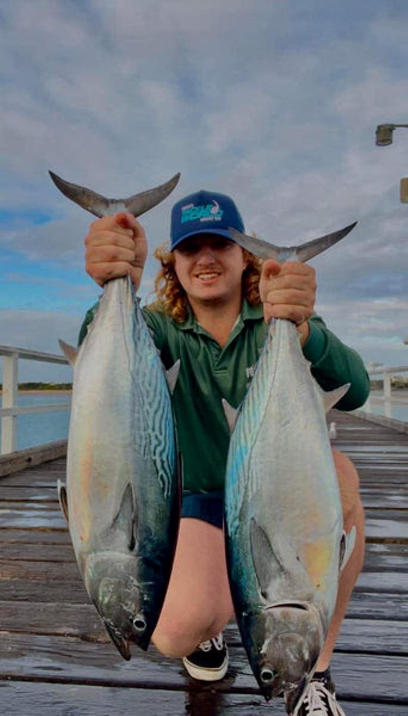 Local lad Tom with two hands full of Urangan Pier mack tuna. Be ready for their marauding raids and throw a lure or live herring in their path - photo © Fisho's Tackle World