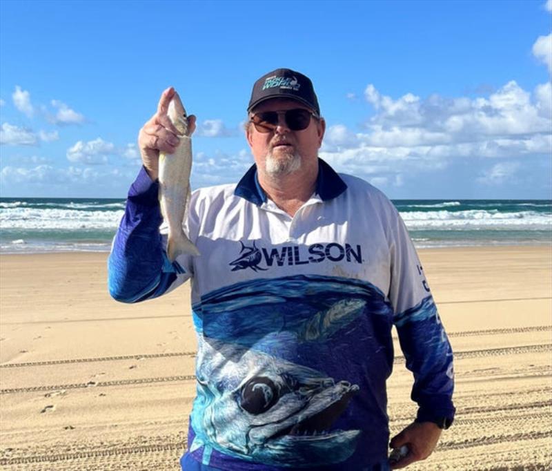 Big Chris Byrnes with a solid Fraser Island Whiting. The fish might not look all that huge, but Chris is a giant of a man - photo © Fisho's Tackle World