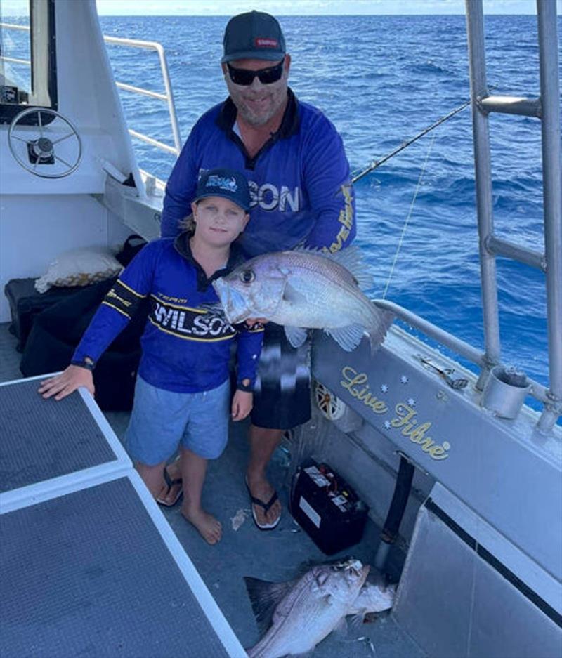 Hauling in pearlies is all just a part of a day out with dad for Ollie Pearce. This young bloke is a young gun in the making - photo © Fisho's Tackle World