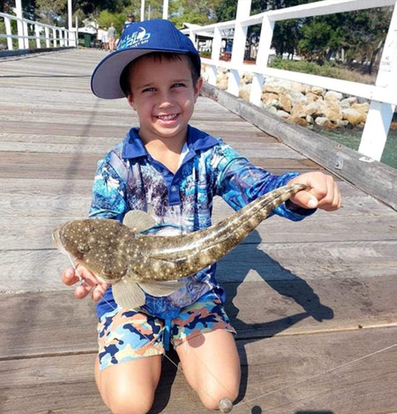 Kingy Ridgeway with his latest land-based capture. With a bit of guidance from his dad, there ain't much this young lad can't catch - photo © Fisho's Tackle World