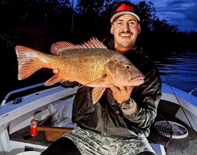Night time, dawn and dusk, are the best times to tangle with mangrove jacks. Here's James with a beauty - photo © Fisho's Tackle World