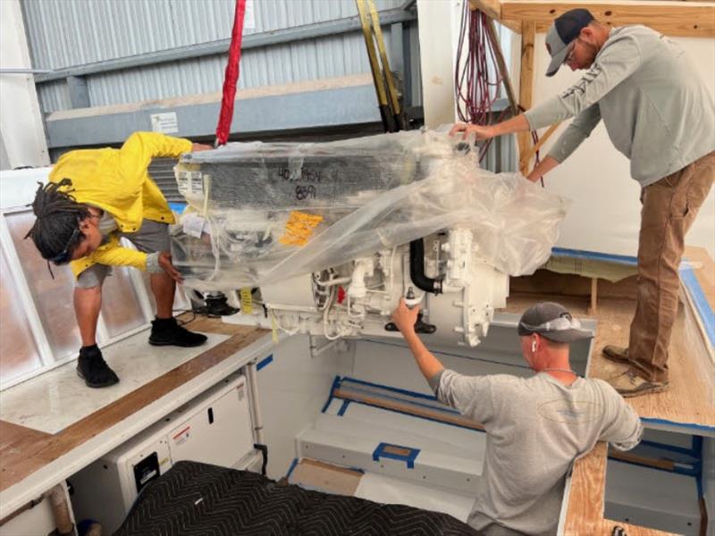 Hull #10 - Chris, Craig, and Dusty guiding starboard engine - photo © Michael Rybovich & Sons