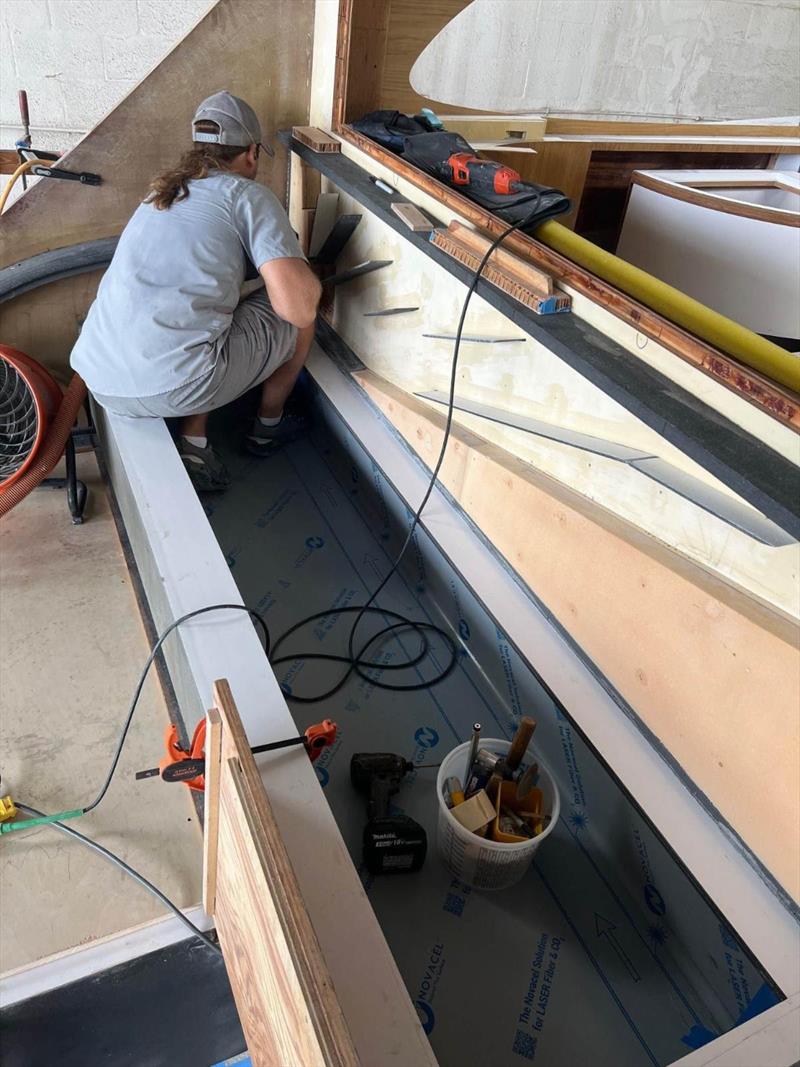 Hull #9 - Paul on the cockpit AC plenum - photo © Michael Rybovich & Sons