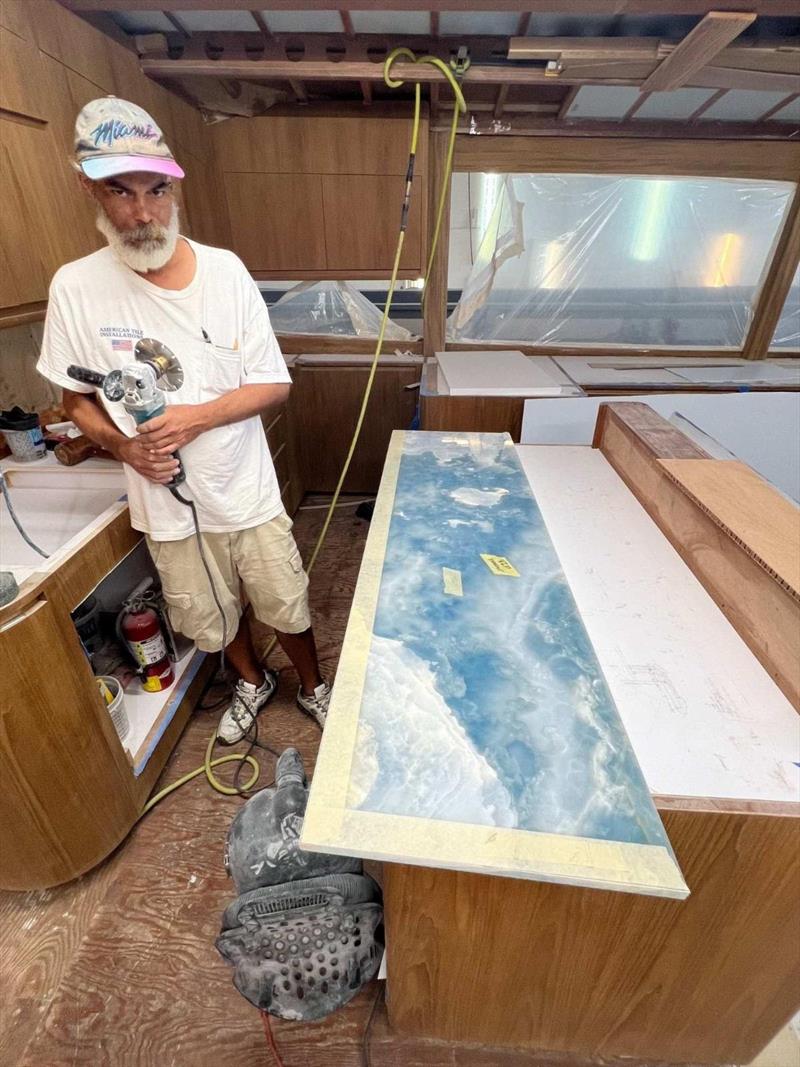 Hull #9 - Steve fitting the stone - photo © Michael Rybovich & Sons