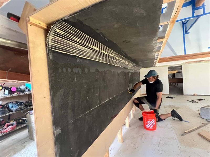 Hull #11 - Scott glassing the mezzanine box - photo © Michael Rybovich & Sons