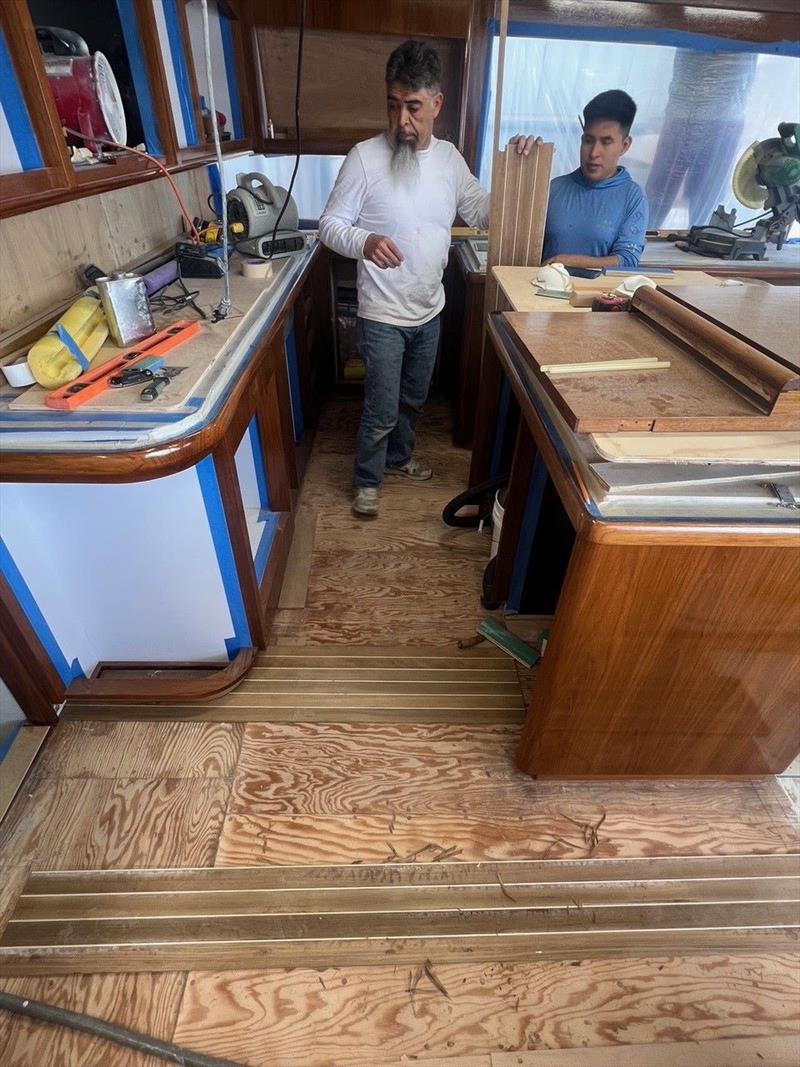 Hull #9 - Miguel and Obilmar installing galley Teak and Holly - photo © Michael Rybovich & Sons