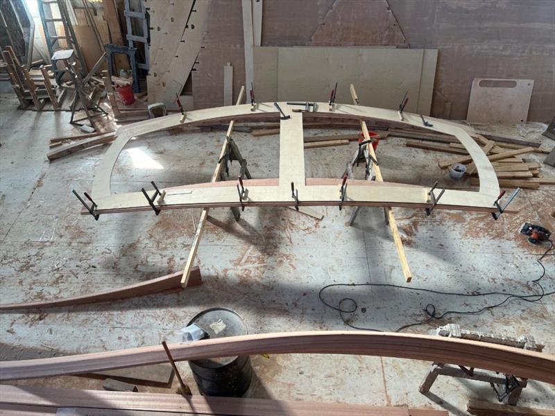 Hull #12 - Assembling the transom frame with laminated stem in foreground - photo © Michael Rybovich & Sons