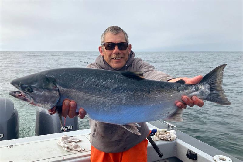 Oregon angler Jim Anderson displays a wild Oregon Coast coho salmon that he caught in the popular coastal fishery for the rebounding species. Although still listed under Endangered Species Act, wild species is productive enough to support a sport fishery photo copyright Lance Kruzic / NOAA Fisheries taken at  and featuring the Fishing boat class