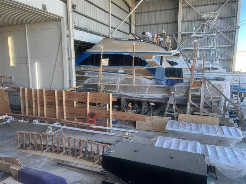 Hull #9 - Prepping bridge handrails - photo © Michael Rybovich & Sons