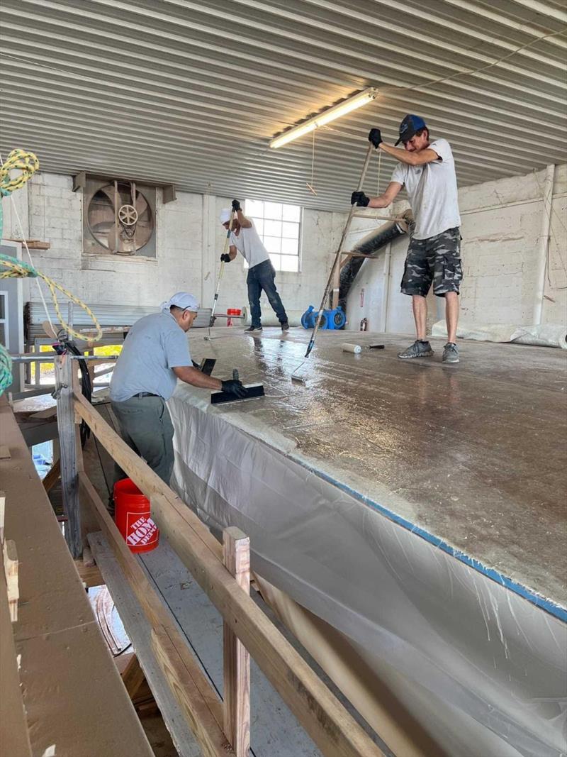 Hull #11 - Sal, Hector, and Flipper glassing foredeck - photo © Michael Rybovich & Sons