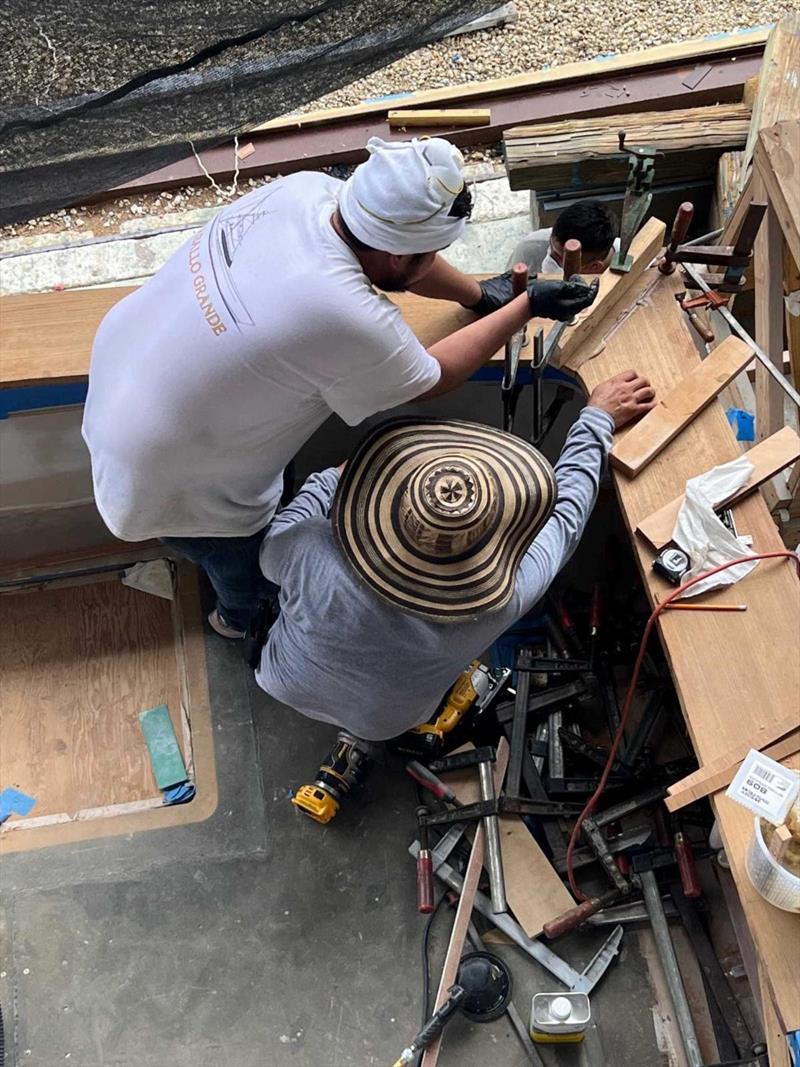 Hull #10 - Miguel and Eric gluing the covering boards - photo © Michael Rybovich & Sons