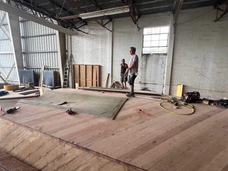 Hull #12 - Glenn and Flipper installing prop tunnels - photo © Michael Rybovich & Sons